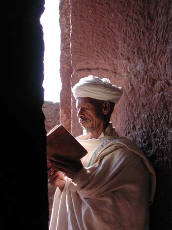Lalibela, in the northern highlands of Ethiopia, is 
famous for its rock-hewn churches. A priest is seen reading a manuscript
 written in the ancient language of Geez. Image courtesy of the Houston
 Museum of Natural Science